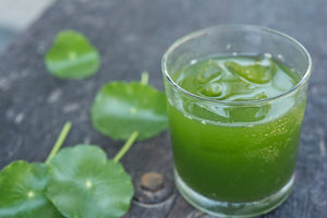 Rockin Wellness Energy Greens superfood pouch with leafy greens for Green Drink in glass